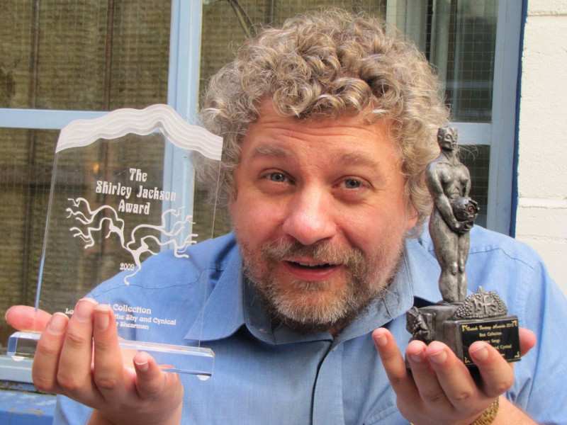 Robert Shearman with some of his awards for Love Songs